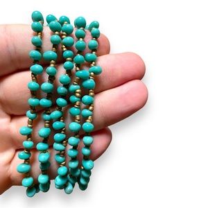 5 elastic gold & teal beaded bracelets.